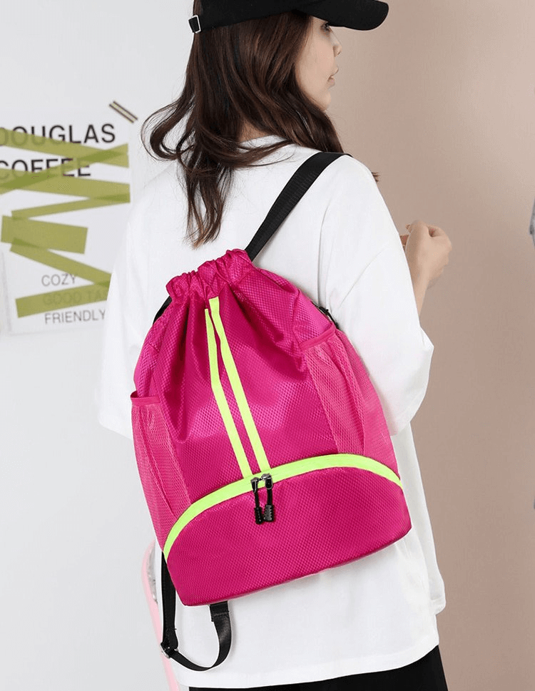 Unisex waterproof sports backpack with 15L capacity shown in pink, ideal for carrying shoes and swim gear. Model showcases versatile design.
